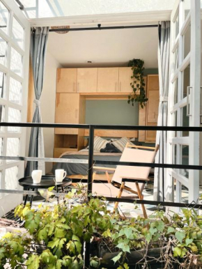 Sunlit Studio with Balcony and Workspace